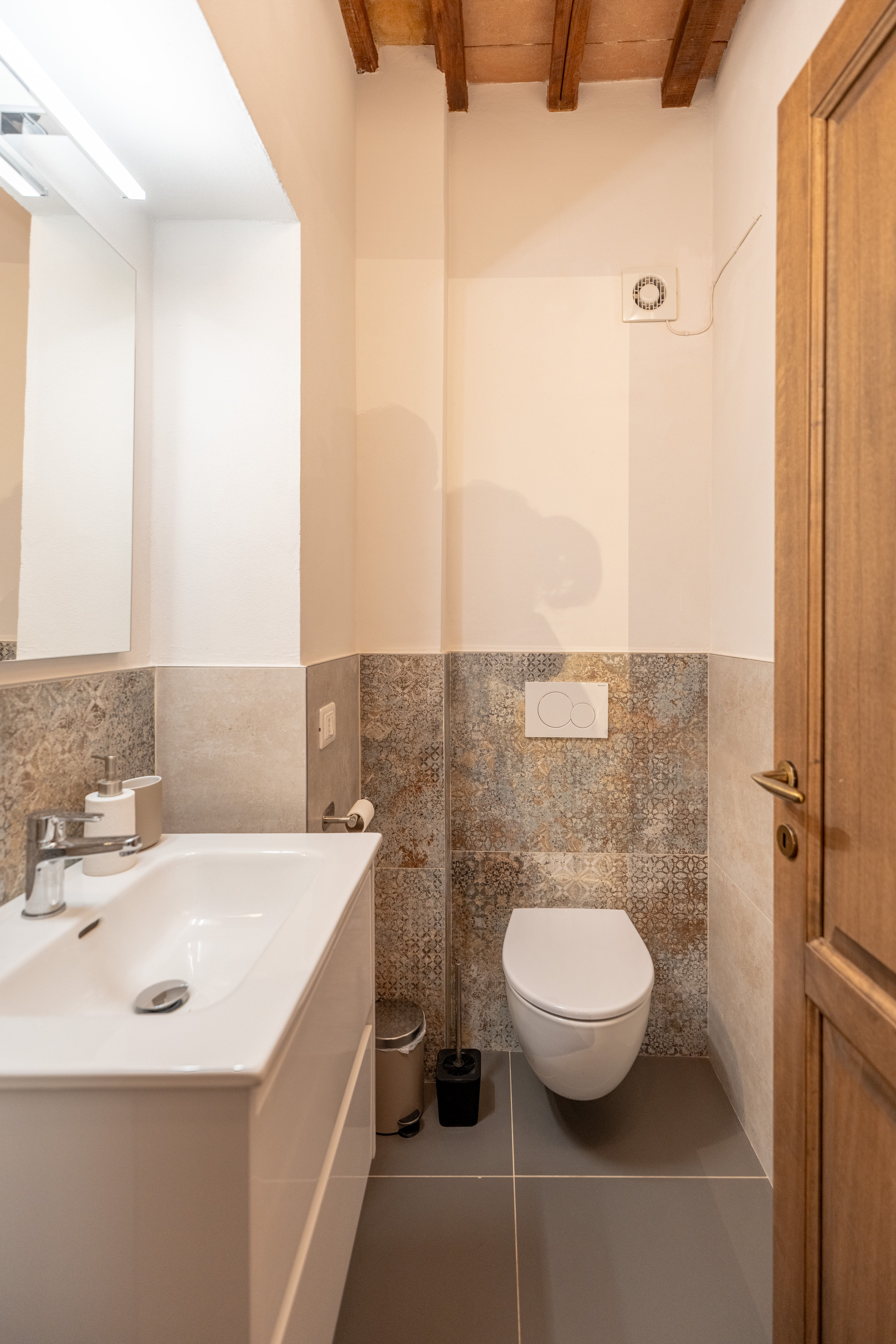 Powder room with mosaic tiles and timber ceiling