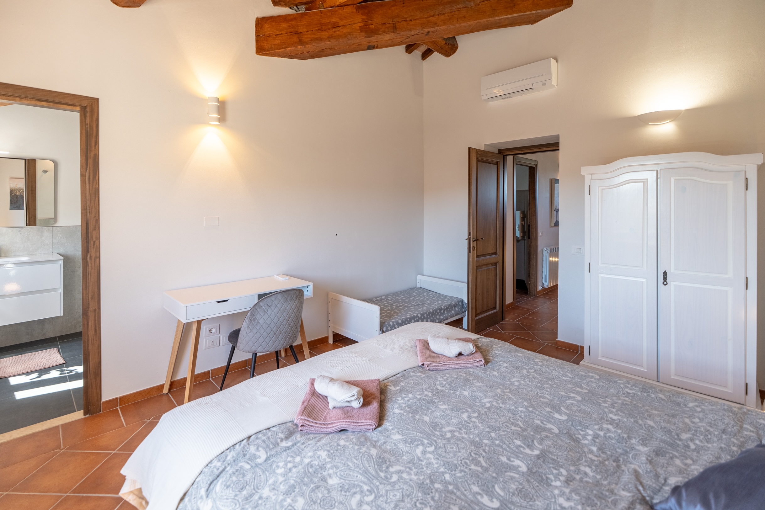 First floor queen bedroom with desk, wardrobe and en-suite bathroom