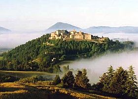 Montone, one of Italy's most beautiful villages — the medieval hilltop town rises dramatically from the forested Umbrian landscape