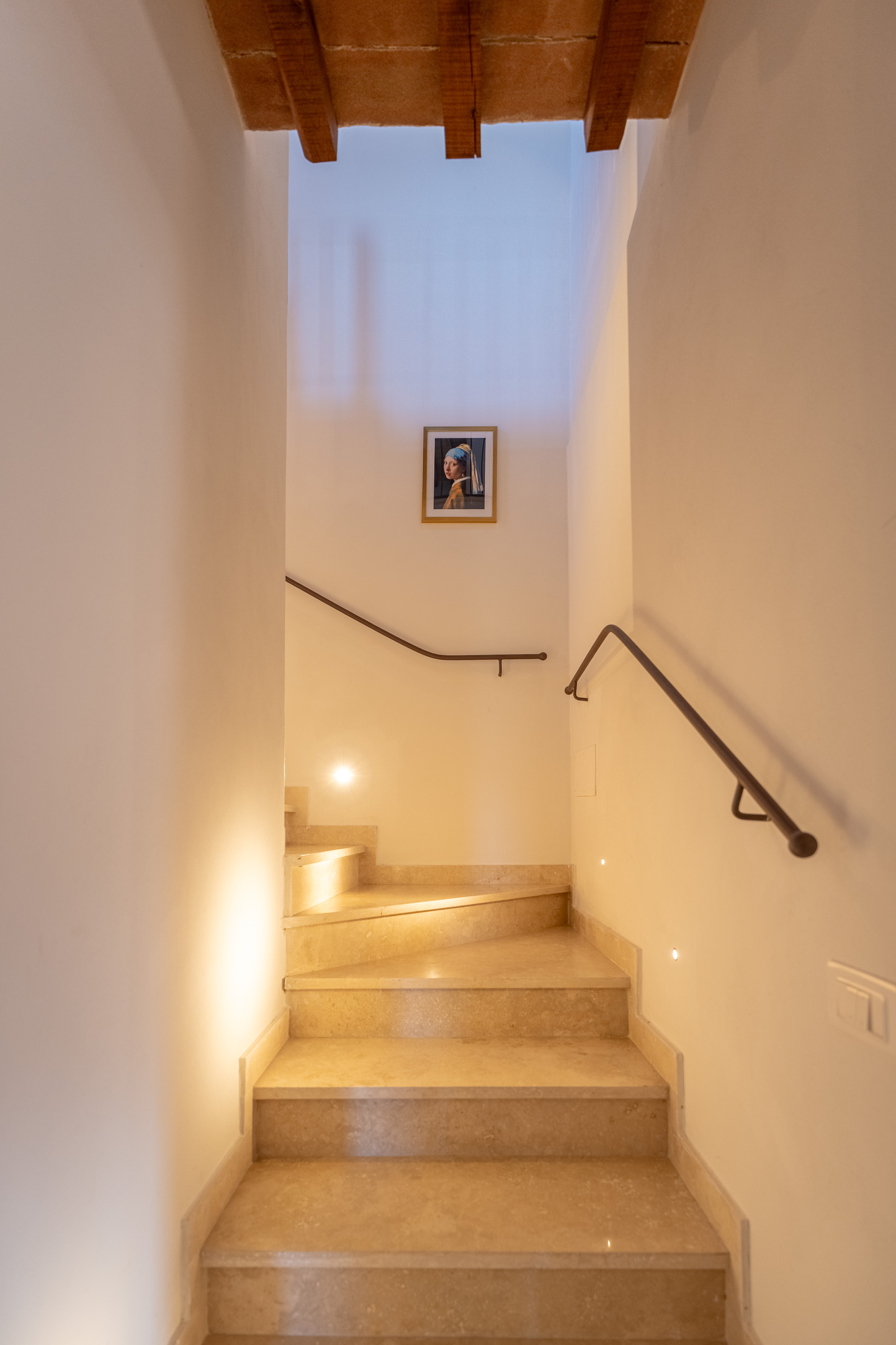 Illuminated marble staircase connecting ground and first floor